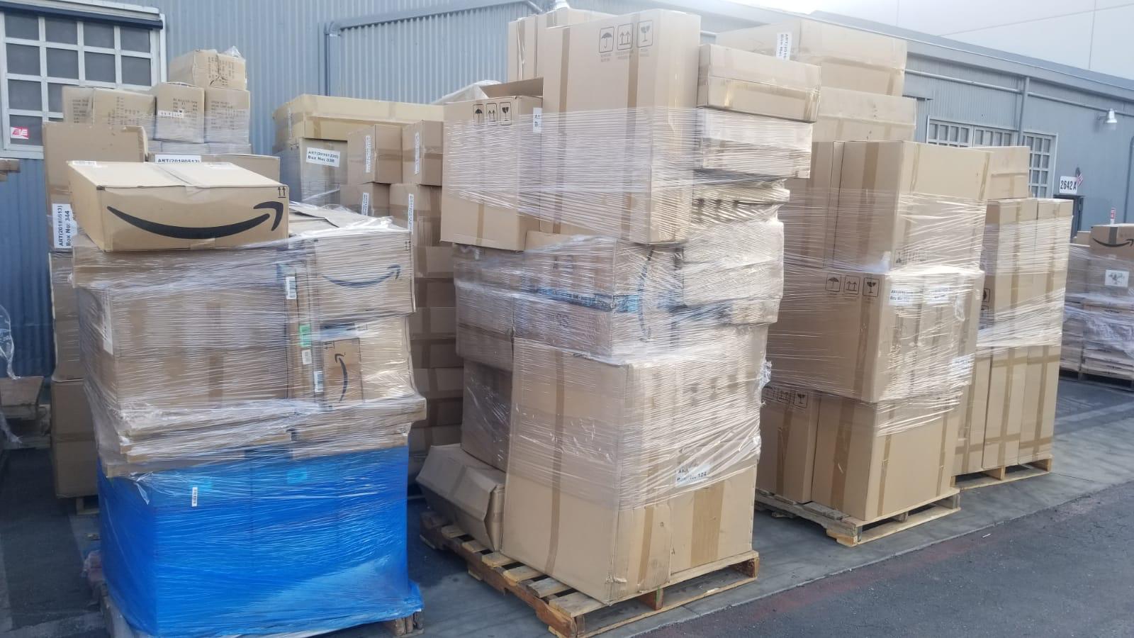 Home Stacked pallets ready for partial shipment and LTL freight transport in Miami warehouse by Dynamic 305 Logistics